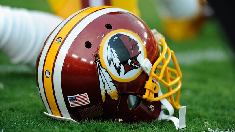 A Washington Redskins helmet sits on the grass during a preseason football game between the Redskins and Cleveland Browns at FedExField on August 18, 2014 in Landover, Maryland.  (Photo by TJ Root/Getty Images)