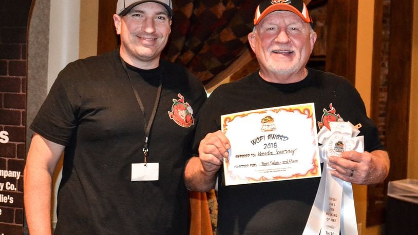 Ryan Stitzel and his father, Greg Stitzel, both of Hamilton, pose with their third place award for Best Salsa at Jungle Jim’s Weekend of Fire Sunday, Oct. 7, 2018. The two men launched their Uncle Snorey business in 2017, offering a Taste Bud Annihilator hot sauce, Jalapeno Relish and Mango Tango Salsa. CONTRIBUTED