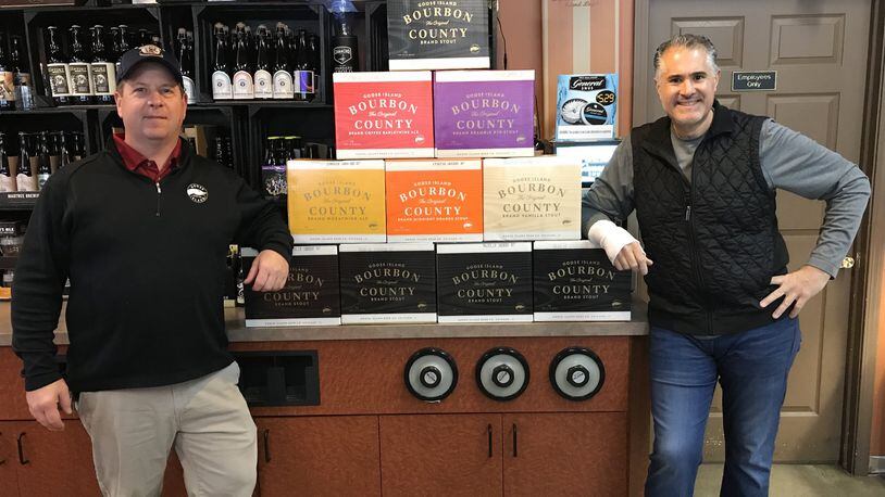 George Karras, right, owner of The Market in Kettering, stands with his shipment of Goose Island Bourbon County Brand Stout at his store.