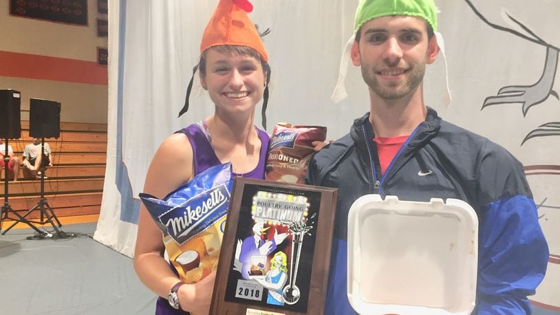 Ryan Stoneberger and his fiancee pose with their prizes after purchasing the One Millionth chicken dinner at Poultry Days in Versailles