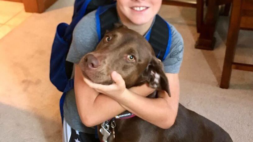 Collin Isaac collected more than 140 pounds of pet food at his birthday party in August. The items will be donated to animals impacted by Hurricane Harvey.  Collin is pictured with his dog Maggie.