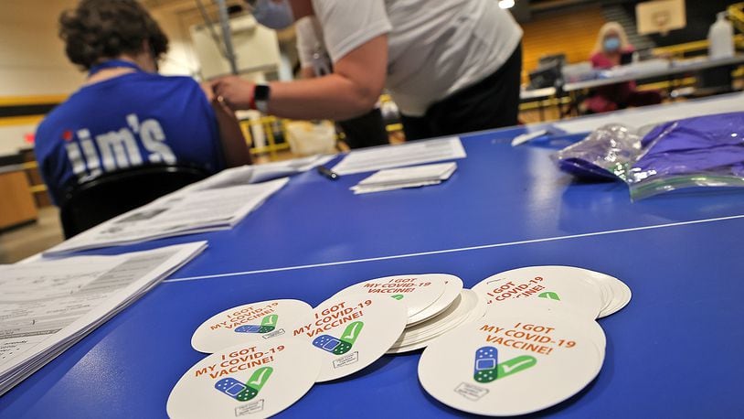 FILE PHOTO A pile of "I Got My COVID-19 Vaccine!" stickers waits for students and adults to get their vaccine shot at a vaccine clinic at Shawnee High School.
