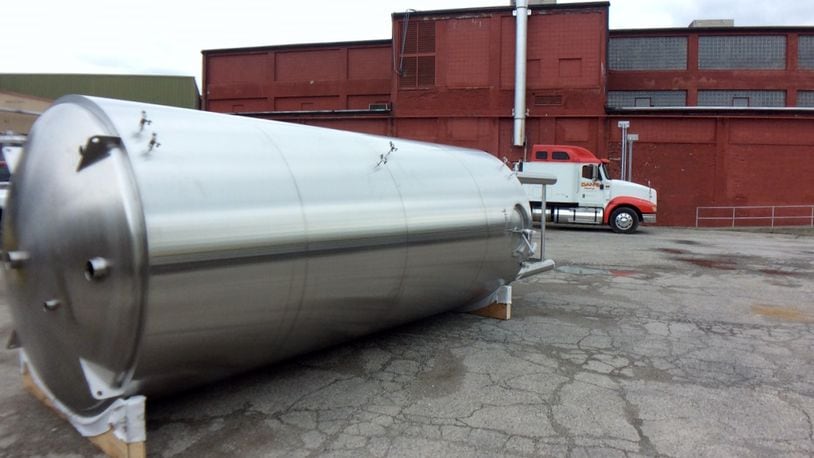 One of the new 120-barrel fermentation tanks awaiting installation Thursday afternoon outside Warped Wing Brewing Company. MARK FISHER/STAFF