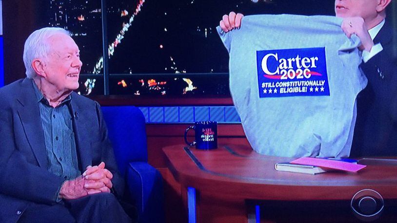 “The Late Show” host Stephen Colbert presents former -- and future? -- President Jimmy Carter with a specially made campaign t-shirt. (Photo courtesy CBS)