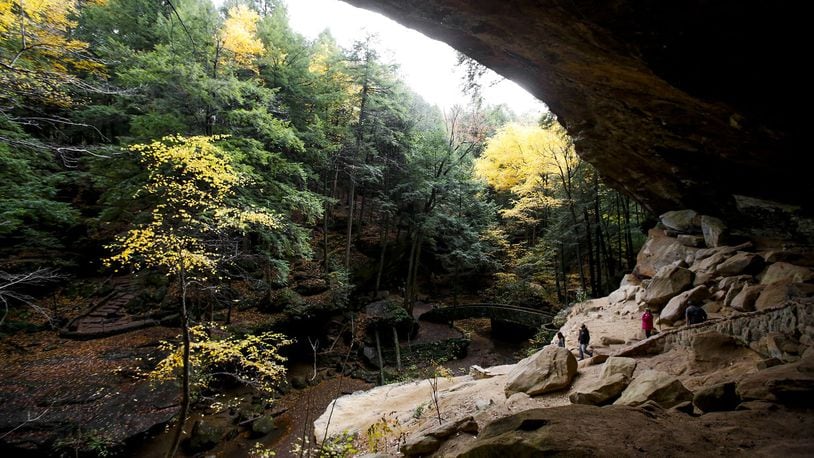 Hikers enjoy the fall foliage and explore Old Man’s Cave at Hocking Hills State Park last fall. (Kristen Zeis, Columbus Dispatch)