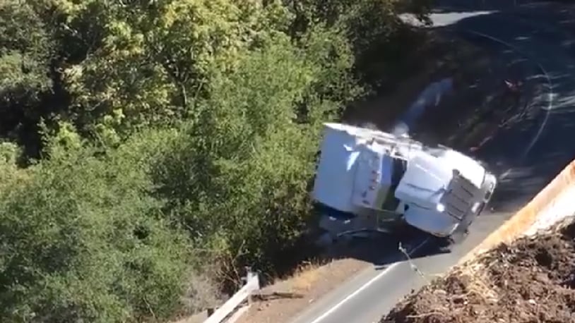 A semi trying to navigate a steep curve fell off an embankment Thursday in California, officials said.