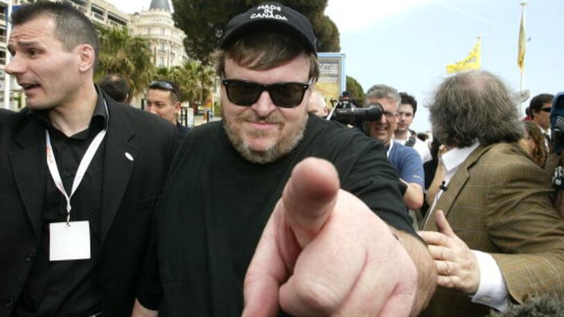 CANNES, FRANCE - MAY 15:  Director Michael Moore lends his support to demonstrating french film workers during the 57th Cannes International Film Festival on the Croisette May 15, 2004 in Cannes, France.  (Photo by Carlo Allegri/Getty Images)