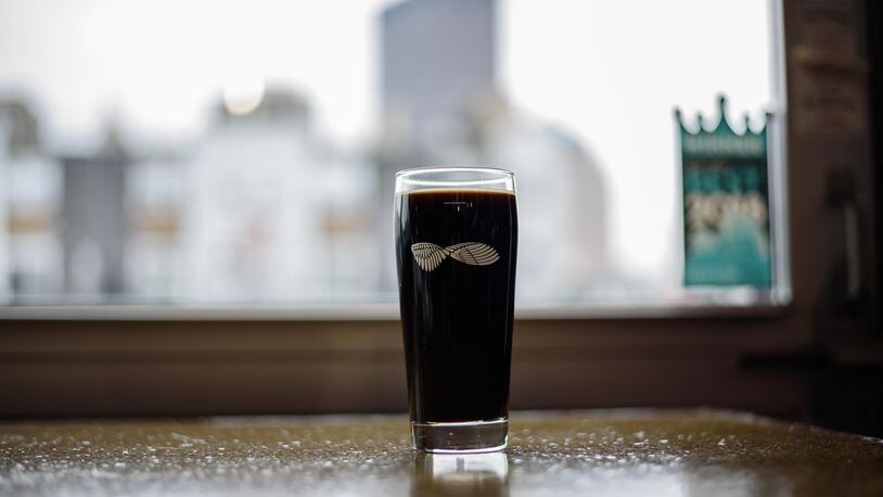 Warped Wing Brewing Company tapped the 10 TON Irish Cream Stout, a special variation of their Oatmeal Stout ahead of St. Patrick's Day at their brewery in downtown Dayton on Saturday, March 9. TOM GILLIAM / CONTRIBUTING PHOTOGRAPHER