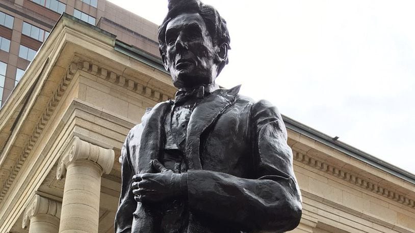 Sculptor Michael Major of Urbana created this bronze sculpture of President Abraham Lincoln as he looked in 1859 when he spoke on the steps of Montgomery County’s Old Court House. The sculpture was unveiled Saturday at Courthouse Square in front of the historic courthouse downtown Dayton. LYNN HULSEY / STAFF