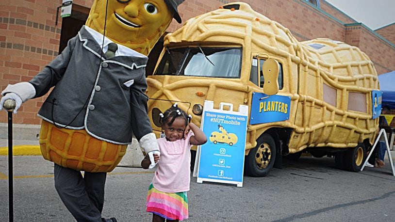 Mr. Peanut and his Nutmoblie posed for pictures with fans, like 4-year-old Jaida Maye, at the Kroger store on Hillcrest Avenue in Dayton on Thursday, Sept. 6, 2018. MARSHALL GORBY / STAFF