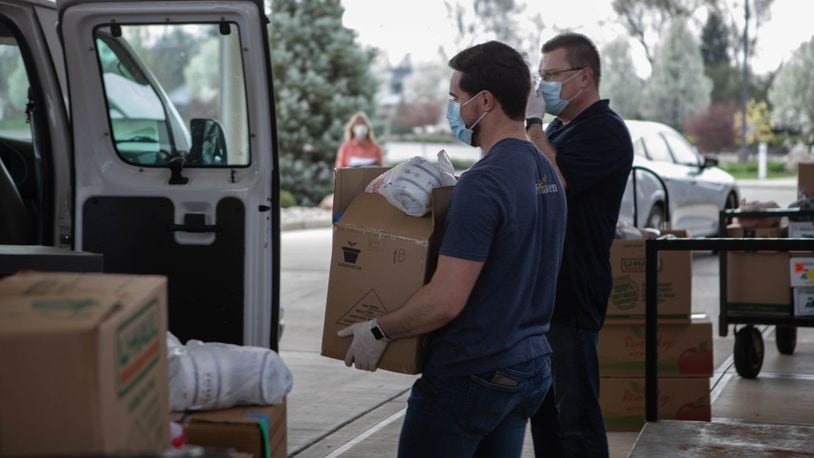 Church volunteers help unload food donations.