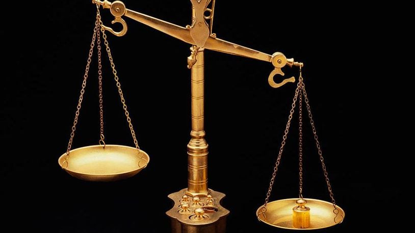 These are the golden Scales of Justice, They represent the legal system and courts, The scales here are shown unbalanced with the left side weighing heavier than the right, They are shown against a black background. (Photo by Visions of America/UIG via Getty Images)