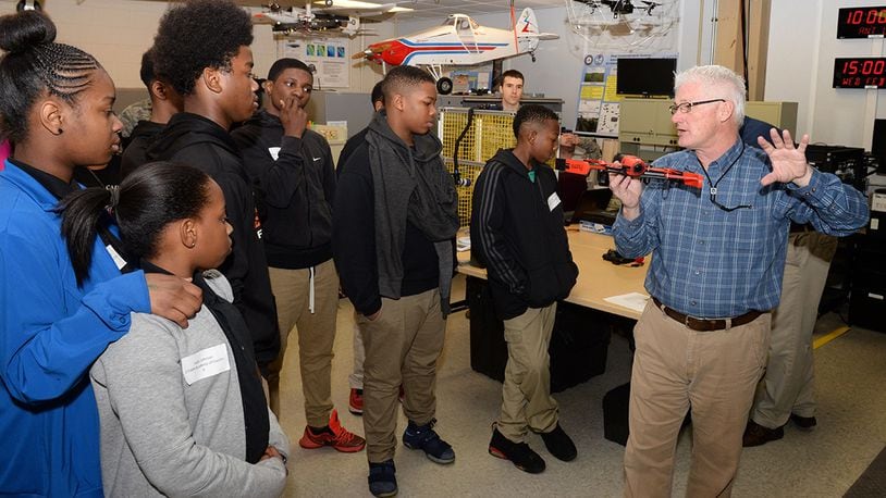 Rick Patton, Air Force Institute of Technology staff engineer shows STEAM Academy of Dayton students a Parrot drone during National Engineers Week at Wright-Patterson Air Force Base, Ohio, Feb. 23, 2017. Patton discussed different forms of drone navigation technology using a WiFi connection. (U.S. Air Force photo by Michelle Gigante)