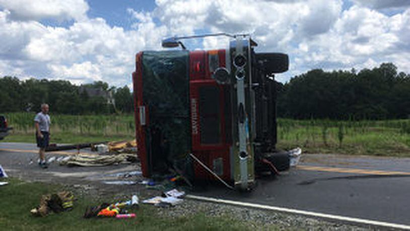 A fire engine flipped over injuring two firefighters while responding to a call. (Photo: WSOCTV.com)