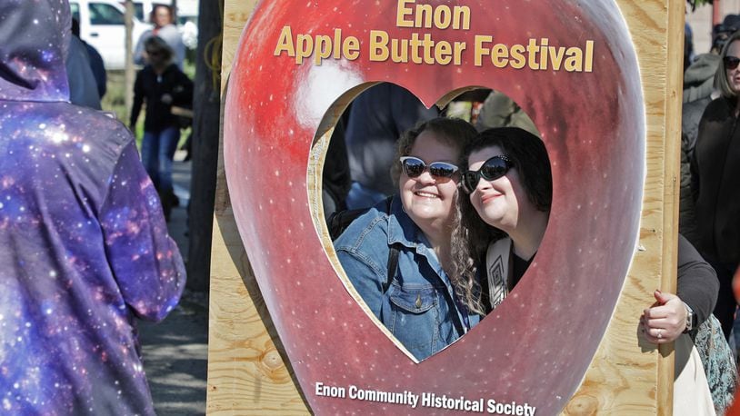 Original cutline: Honey Greene, left, and Wendy Adams pose for a picture in a cut out at the Enon Apple Butter Festival Saturday. BILL LACKEY/STAFF