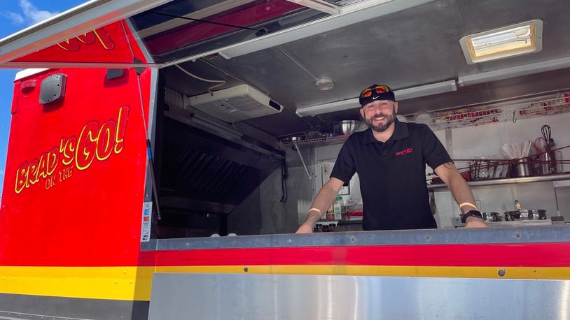 If you’re looking for a late-night food option in Dayton’s Oregon District, Brad’s on the Go! is offering a rotating menu of tacos, nachos, tater barrels, walking tacos and more outside of NextDoor. Pictured is Owner Brad Hamilton. NATALIE JONES/STAFF
