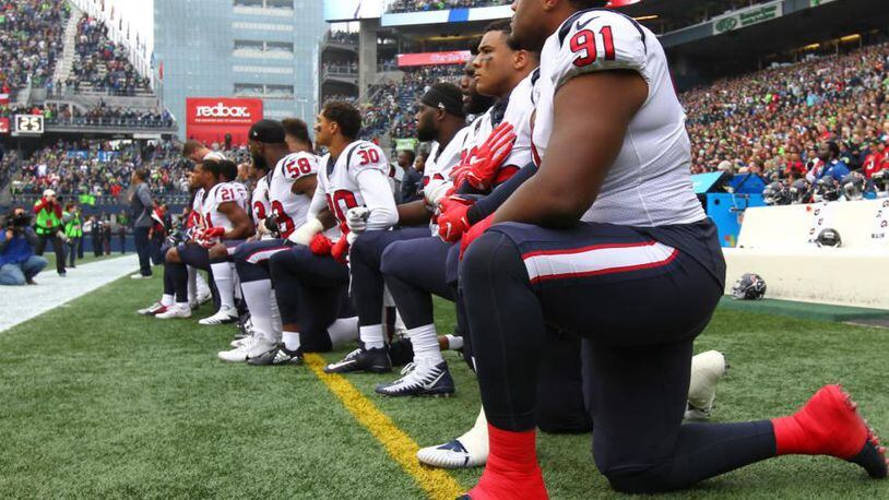 SEATTLE, WA - OCTOBER 29:  Members of the Houston Texans kneel during the national anthem before the game against the Seattle Seahawks at CenturyLink Field on October 29, 2017 in Seattle, Washington. During a meeting of NFL owners earlier in October, Houston Texans owner Bob McNair said "we can't have the inmates running the prison," referring to player demonstrations during the national anthem. (Photo by Jonathan Ferrey/Getty Images)