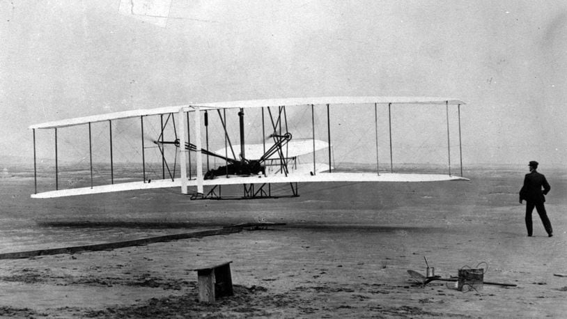 Orville Wright is at the controls of the "Wright Flyer" as his brother Wilbur Wright looks on during the plane's first flight at Kitty Hawk, N.C., in this Dec. 17, 1903 file photo.