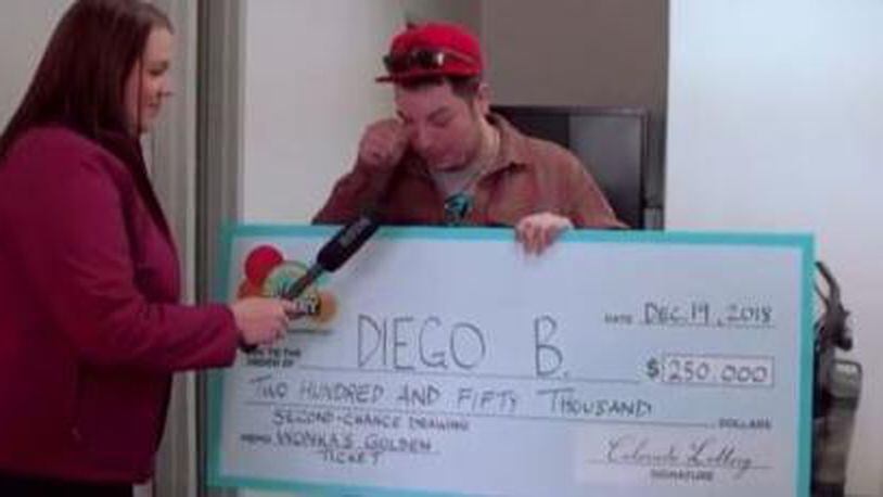 Diego B. looks on in disbelief after being handed a check for $250,000.