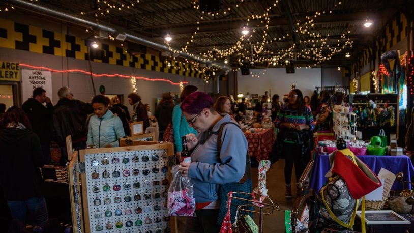 Local vendors set up shop with handmade wares to give and get for the holidays at the Old Yellow Cab Tavern in Dayton. (TOM GILLIAM)