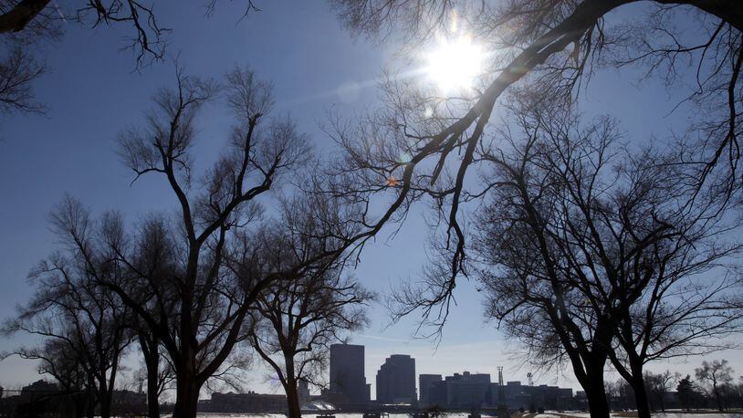 The sun shines over a view of the downtown Dayton skyline from Deeds Point MetroPark. LISA POWELL / STAFF