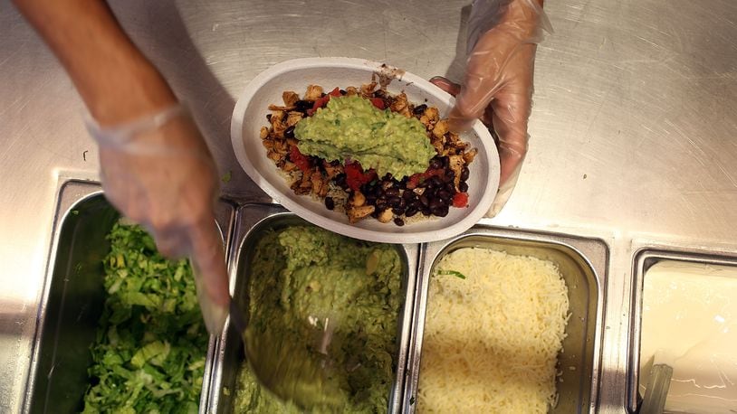 MIAMI, FL - APRIL 27: Chipotle restaurant workers fill orders for customers on the day that the company announced it will only use non-GMO ingredients in its food on April 27, 2015 in Miami, Florida. (Photo by Joe Raedle/Getty Images)