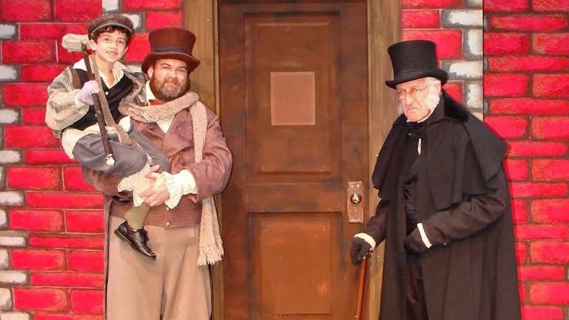 Sam Kingrey (Tiny Tim), David Goins (Bob Cratchit) and Chris Kramer (Scrooge) appear in La Comedia Dinner Theatre’s presentation of “A Christmas Carol” through Saturday, Dec. 31. The show features a score by Angelyn Fullarton Benson and Bobby Cronin. CONTRIBUTED