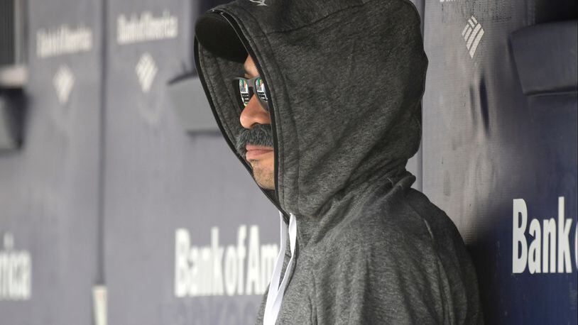 Ichiro Suzuki, special assistant to the chairman of the Seattle Mariners, wears a fake mustache and a hoodie as he sits in the dugout and watches the New York Yankees bat during the first inning of Thursday's baseball game.