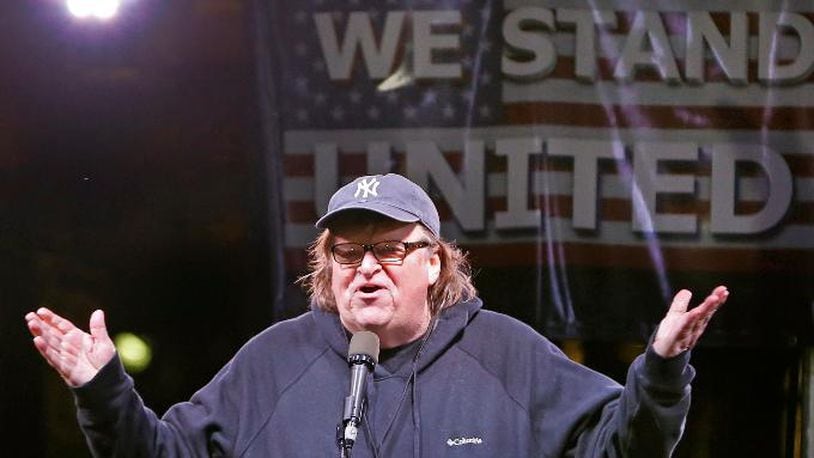 File- This Jan. 19, 2017, file photo shows  filmmaker Michael Moore speaking to thousands of people at an anti-Trump rally and protest in front of the Trump International Hotel in New York. (AP Photo/Kathy Willens. File)