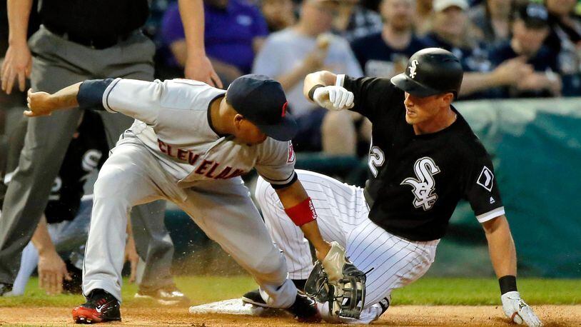 CHICAGO, IL - JUNE 13: Charlie Tilson #22 of the Chicago White Sox beats the tag of Jose Ramirez #11 of the Cleveland Indians for an RBI triple during the fifth inning at Guaranteed Rate Field on June 13, 2018 in Chicago, Illinois.  (Photo by Jon Durr/Getty Images)