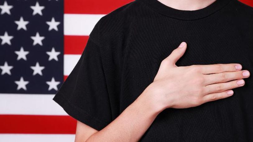Hand on heart for American flag (stock photo).