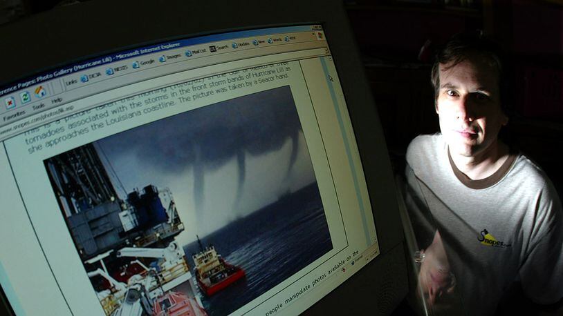 [2004 Photo] David Mikkelson next to his computer monitor with a doctored storm photo in which two extra tornados were added to the original which had only one. (Photo by Stephen Osman/Los Angeles Times via Getty Images)