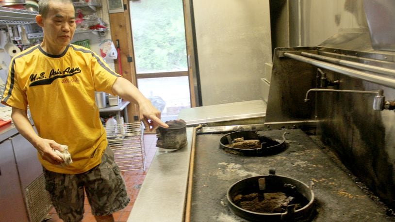 Little Saigon Restaurant,  1718 Woodman Dr. in Kettering, plans to reopen July 25. Bao Thoi, a co-owner,  points to damaged caused by the fire and the fire suppression system.