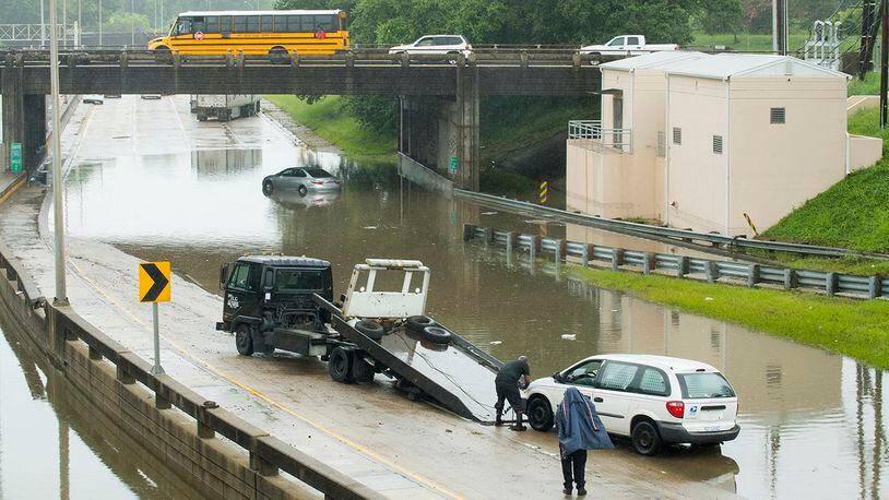 A towing service prepares to hauls out a U.S. Postal Service van from the I-110 southbound curves near the Governor's Mansion, as a result of flash flooding from heavy rains, Thursday, June 6, 2019, in Baton Rouge, La.  (Travis Spradling/The Advocate via AP)