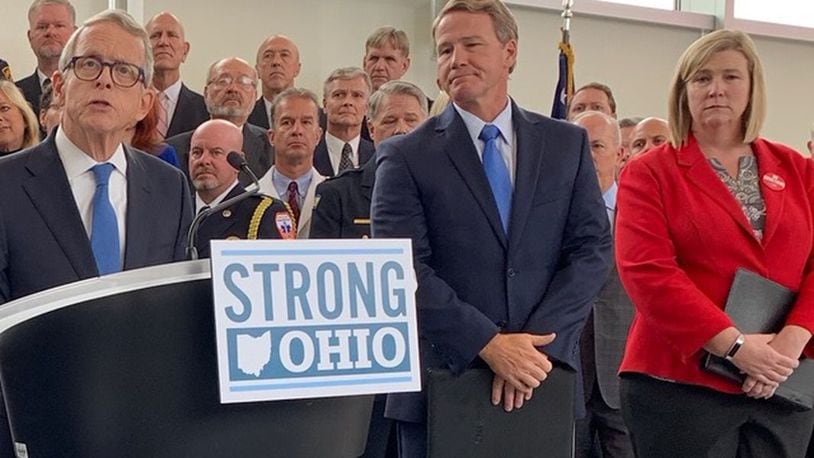 Gov. Mike DeWine announces his Strong Ohio gun bill plan Monday, Oct. 7, 2019, in Columbus. Lt. Gov. Jon Husted and Dayton Mayor Nan Whaley are to his right. Photo by Laura Bischoff