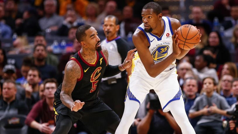 Kevin Durant #35 of the Golden State Warriors holds the ball against JR Smith #5 of the Cleveland Cavaliers at Quicken Loans Arena on January 15, 2018 in Cleveland, Ohio.