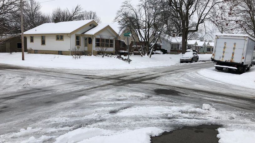 Snow and ice cover pavement at the corner of Springmont and Russell in east Dayton on Monday, Aug. 14, 2019.