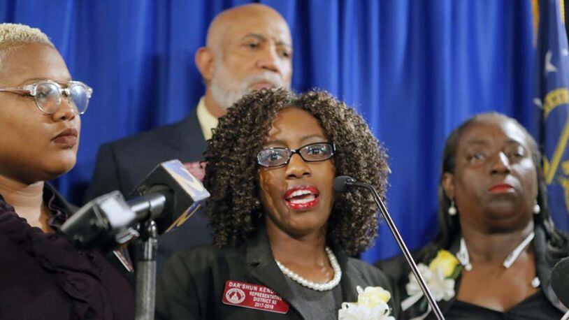 State Rep. Dar’shun Kendrick, a Lithonia Democrat, center, announced plans to file legislation regulating men’s reproductive health issues, similar to a strict anti-abortion bill making its way through the Senate.