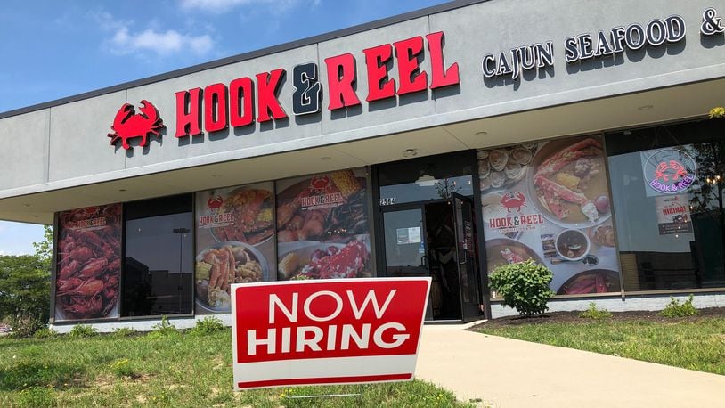 A new seafood restaurant, Hook & Reel Cajun Seafood & Bar, opens today, Aug. 18, 2020, in the building that formerly housed a Sears Tire & Auto center at the Dayton Mall. Hook & Reel shares the building with Outback Steakhouse, which opened last year. MARK FISHER/STAFF