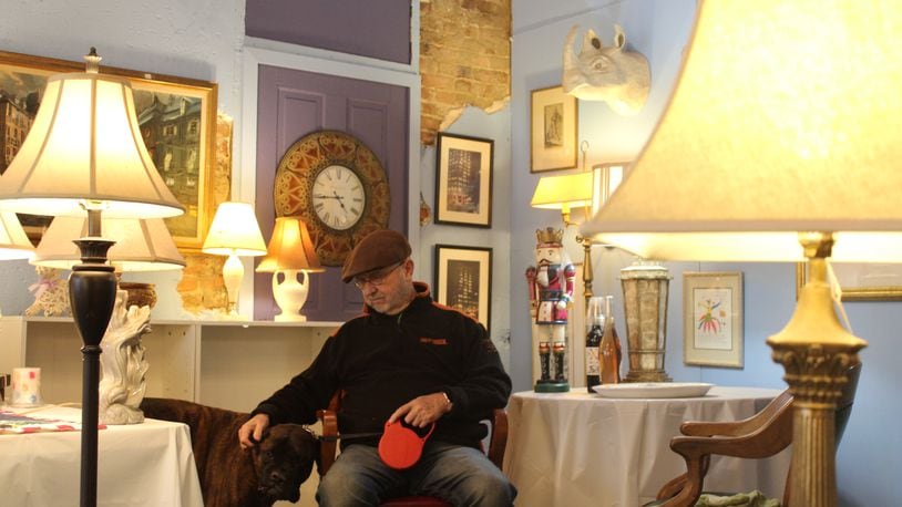 Harry Slone and his dog “Mr. Red” in his new store on East Fifth Street in St Anne’s Hill. CORNELIUS FROLIK / STAFF