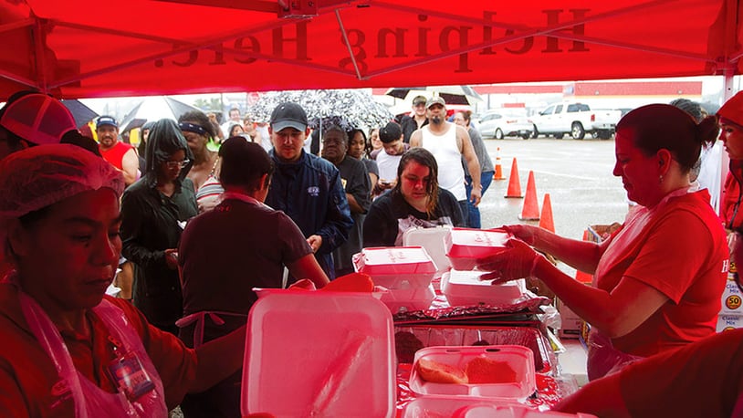 H-E-B Grocery Stores set up a Mobile Kitchen in the parking lot of their location in Victoria, Texas to help provide free hot meals to those affected by Hurricane Harvey on Sunday, Aug. 27, 2017. (Nicolas Galindo/The Victoria Advocate via AP)
