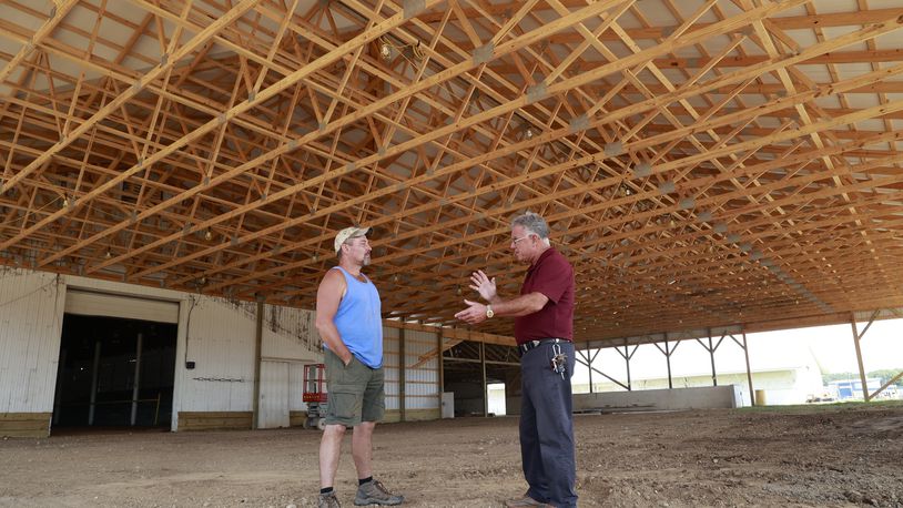 Dean Blair, executive director of the Clark County Fairgrounds talks with Robert Haffner, the maintenance manager at the fairgrounds, as they stand in the new addition that has been added to the Cattle Barn Arena Tuesday, July 11, 2023. BILL LACKEY/STAFF