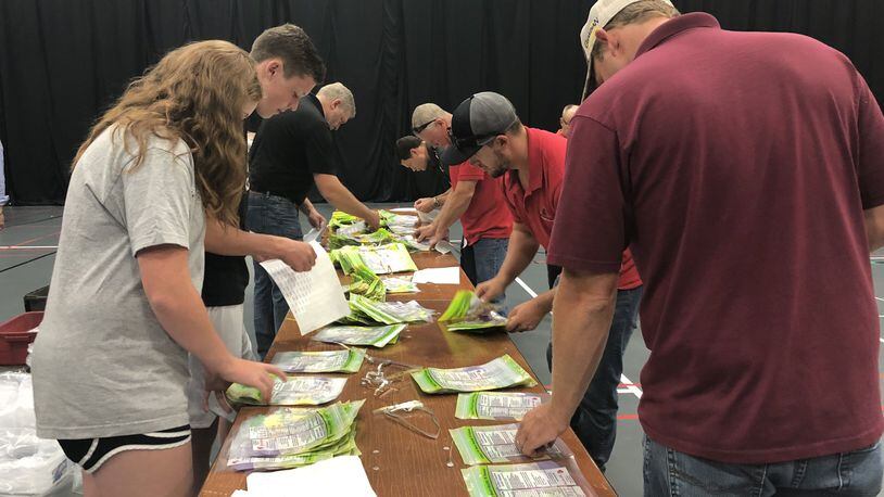 Members of Discover Point Church in Kettering pack meals at the Nutter Center for local children in backpack meal programs.
