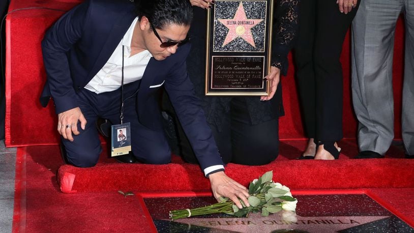 Selena's widower Chris Perez lays flowers at the singer's star on the Hollywood Walk of Fame on Friday night.