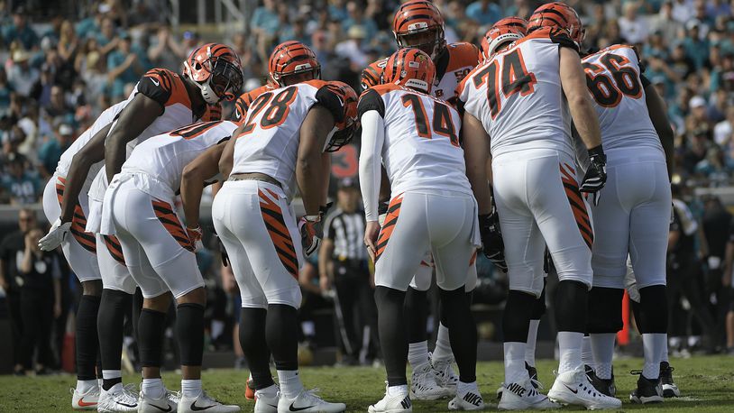 Cincinnati Bengals quarterback Andy Dalton (14) calls a play in the huddle during the first half of an NFL football game against the Jacksonville Jaguars, Sunday, Nov. 5, 2017, in Jacksonville, Fla. (AP Photo/Phelan M. Ebenhack)