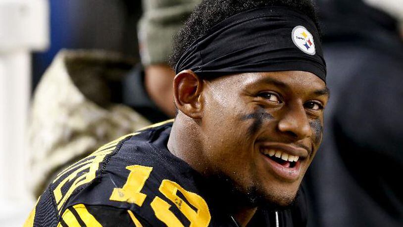 FILE - In this Nov. 16, 2017, file photo, Pittsburgh Steelers wide receiver JuJu Smith-Schuster (19) smiles on he sideline during an NFL football game against the Tennessee Titans, in Pittsburgh. Pittsburgh Steelers rookie wide receiver JuJu Smith-Schuster and Cincinnati Bengals cornerback George Iloka have been suspended one game each by the NFL for violating league safety rules. Smith-Schuster was flagged for unnecessary roughness and taunting after a blindside hit on Bengals linebacker Vontaze Burfict in the fourth quarter of Pittsburgh's 23-20 victory Monday night, Dec. 5. Iloka was penalized for unnecessary roughness for a helmet-to-helmet hit on Steelers wide receiver Antonio Brown. (AP Photo/Keith Srakocic, File)