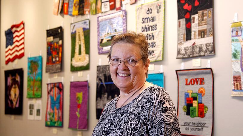 Cathy Jeffers organized a"Dayton Strong, A Quilt Show" on display at the Woodbourne Library in Centerville through Dec. 2. The exhibition is the Creative Quilters Guild's response to the May Ku Klux Klan rally in Dayton, the Memorial Day tornadoes and the Oregon District shootings. LISA POWELL / STAFF