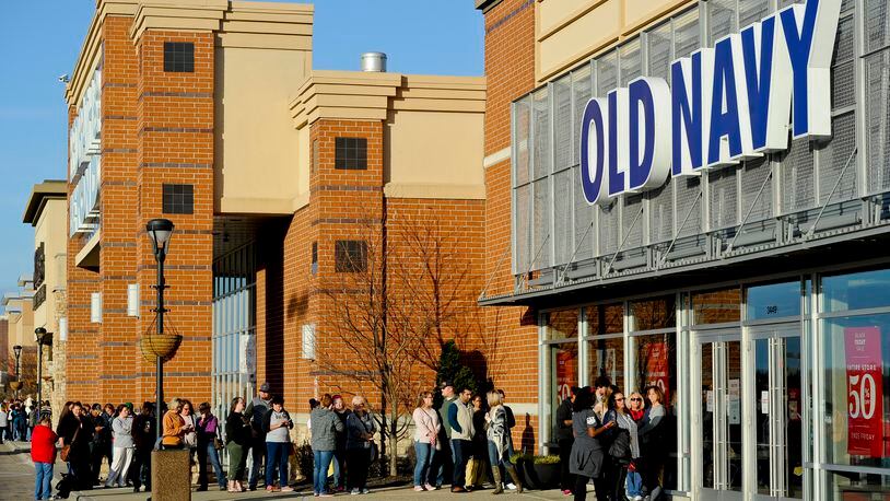 Shoppers wait in line outside the Old Navy store at Bridgewater Falls to take advantage of the pre-Black Friday sales on Thanksgiving Day last year. NICK GRAHAM/STAFF