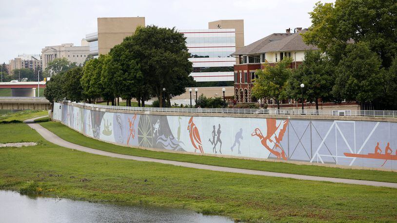 The River Run Mural spans 950 feet next to the Great Miami River across from RiverScape Metro Park. Designed by artist Amy Deal it was painted on the flood wall by artists from K12 Gallery. River Run opens on May 5 LISA POWELL / STAFF